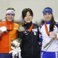 Women\'s 1,500-meter winner Miho Takagi (center) poses with second-place finisher Marrit Leenstra (left) and Yekaterina Shikhova, who finished third, following the race at a World Cup speedskating event on Saturday in Salt Lake City. | AP