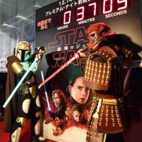 Some of the nearly thousand \"Star Wars\" fans — many dressed as their favorite heroes and villains from the film franchise —  wait in excitement outside Toho Cinemas\' Roppongi theater in Tokyo\'s Minato Ward for the Japanese premiere of \"The Last Jedi\" on Thursday. | SATOKO KAWASAKI