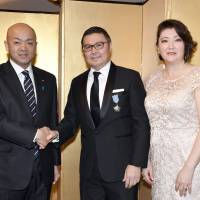 Kazakhstan Ambassador Yerlan Baudarbek-Kozhatayev (center) and his wife, Manshuk,      welcome Manabu Horii, parliamentary vice-minister of foreign affairs, during a reception      to celebrate of the 26th anniversary of the Republic of Kazakhstan\'s independence at Hotel Okura Tokyo on Dec. 19. | YOSHIAKI MIURA