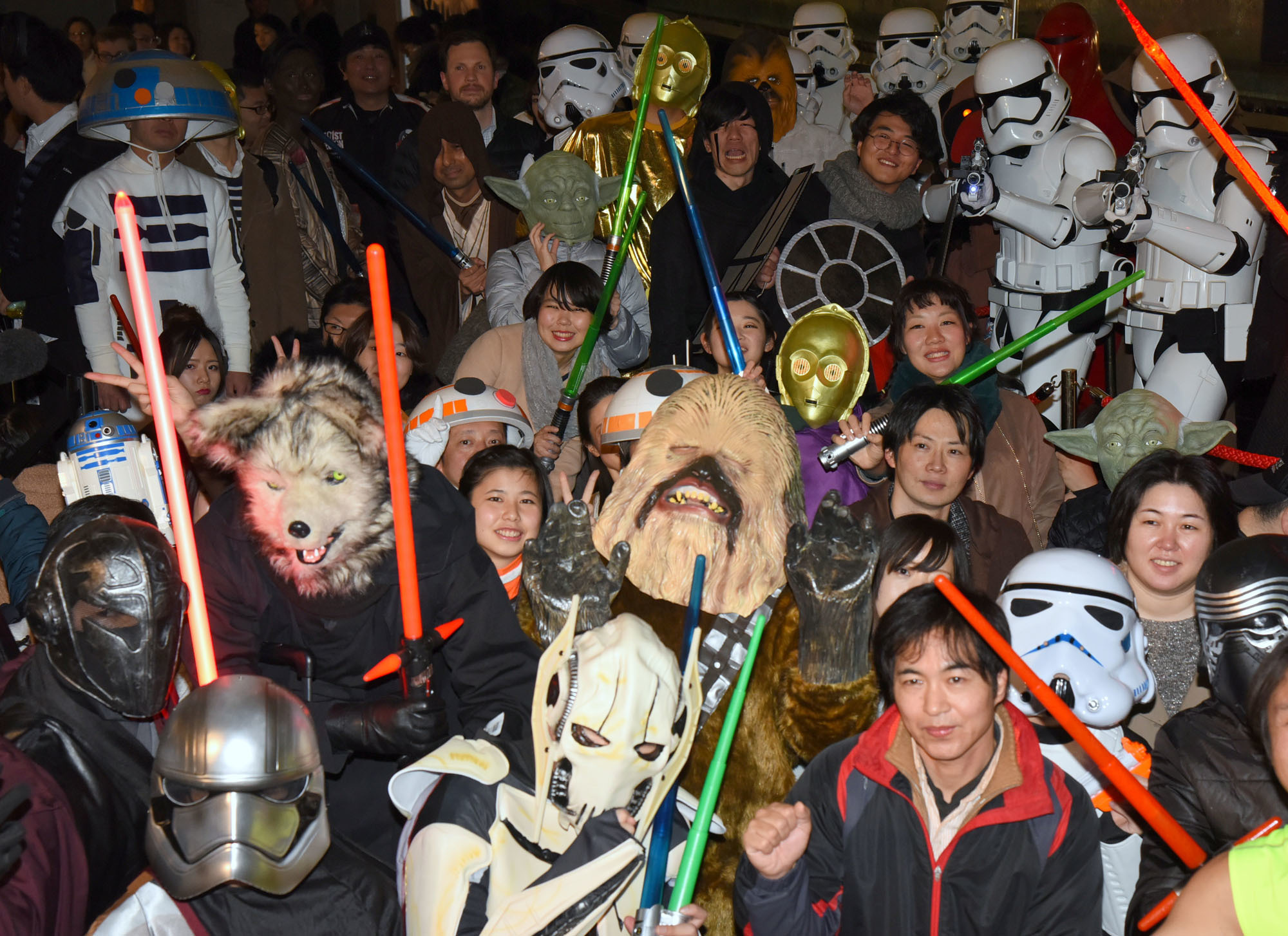 Some of the nearly thousand 'Star Wars' fans &#8212; many dressed as their favorite heroes and villains from the film franchise &#8212;  wait in excitement outside Toho Cinemas' Roppongi theater in Tokyo's Minato Ward for the Japanese premiere of 'The Last Jedi' on Thursday. | SATOKO KAWASAKI