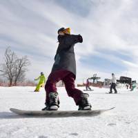 Snowboarders and skiers hit the slopes at the Gokase Highland Ski &amp; Snowboard resort in Miyazaki Prefecture on Friday. Japan\'s southernmost ski resort opened for the winter the same day with the help of machine-made snow. | KYODO