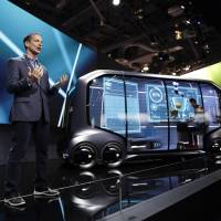 John Scumniotales, of Amazon Alexa Automotive, stands next to the Toyota e-Pallet concept vehicle at a news conference at CES International on Tuesday in Las Vegas. | AP