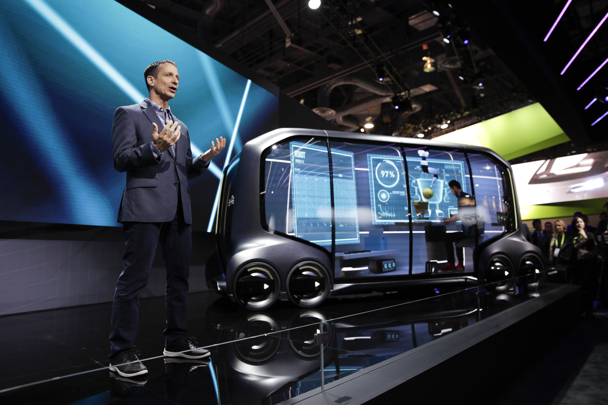 John Scumniotales, of Amazon Alexa Automotive, stands next to the Toyota e-Pallet concept vehicle at a news conference at CES International on Tuesday in Las Vegas. | AP