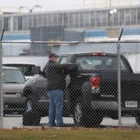 A worker prepares to exit the Carrier Corporation HVAC manufacturing plant ahead of an expected second-round of layoffs in Indianapolis Wednesday. | REUTERS