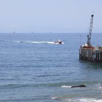 Oil drills lief offshore of a service pier in the Santa Barbara Channel off the coast of Southern California near Carpinteria in 2015. Opposition to the Trump administration\'s plan to expand offshore drilling mounted. The plan could open up federal waters off the California coast for the first time in more than three decades. | AP