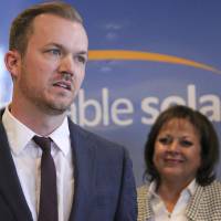 Affordable Solar President Kevin Bassalleck talks about the full-time positions his company will create as New Mexico Gov. Susana Martinez listens during a news conference in Albuquerque last February. | AP