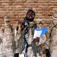 The leader of one of the Boko Haram group\'s factions, Abubakar Shekau, speaks in front of guards in an unknown location in Nigeria in this still image taken from an undated video obtained on Monday. | BOKO HARAM HANDOUT / SAHARA REPORTERS / VIA REUTERS