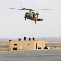 Jordanian army members participate in a hostage rescue drill during a Black Hawk helicopter handover ceremony to Jordan from the U.S. government, at a Jordanian military base near the town of Zarqa Sunday. | REUTERS