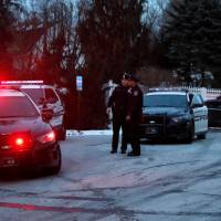 Police vehicles are seen outside the home of former U.S. President Bill Clinton and former Democratic presidential candidate Hillary Clinton after firefighters were called to put out a fire at the property in Chappaqua, New York, Wednesday. | REUTERS