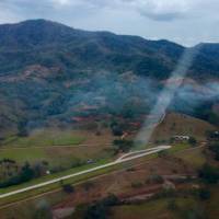This photo released by Costa Rica\'s Public Safety Ministry shows smoke rising from the site of a plane crash near an airstrip in Punta Islita, Guanacaste, Costa Rica, Sunday. | COSTA RICA\'S PUBLIC SAFETY MINISTRY / VIA AP