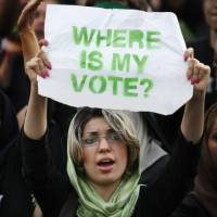 A demonstrator holds a placard as hundreds of thousands people protest election results in Tehran in June 2009. | AP