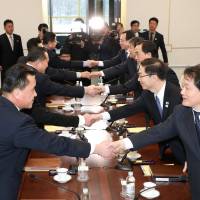 South and North Korean delegates attend their meeting at the truce village of Panmunjom in the Demilitarised Zone separating the two Koreas Tuesday. | YONHAP / VIA REUTERS