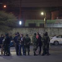 Members of the Mexican army monitor the area where seven people were killed inside a house while they were watching a soccer game in Monterrey, Mexico, Sunday. | AFP-JIJI