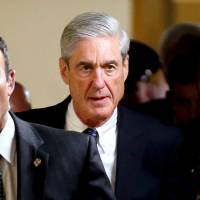 Special Counsel Robert Mueller (right) departs after briefing members of the U.S. Senate on his investigation into potential collusion between Russia and the Trump campaign on June 21, 2017. | REUTERS