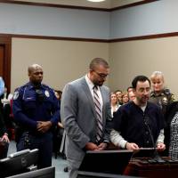 Larry Nassar,a former team USA Gymnastics doctor who pleaded guilty in November to sexual assault charges, makes a statement in the courtroom during his sentencing hearing in Lansing, Michigan, Wednesday. | REUTERS
