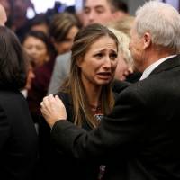 Michigan State University Police Chief Jim Dunlap embraces victim Kyle Stephens after the sentencing of Larry Nassar, a former team USA Gymnastics doctor who pleaded guilty in November  to sexual assault charges, in Lansing, Michigan, Wednesday. | REUTERS