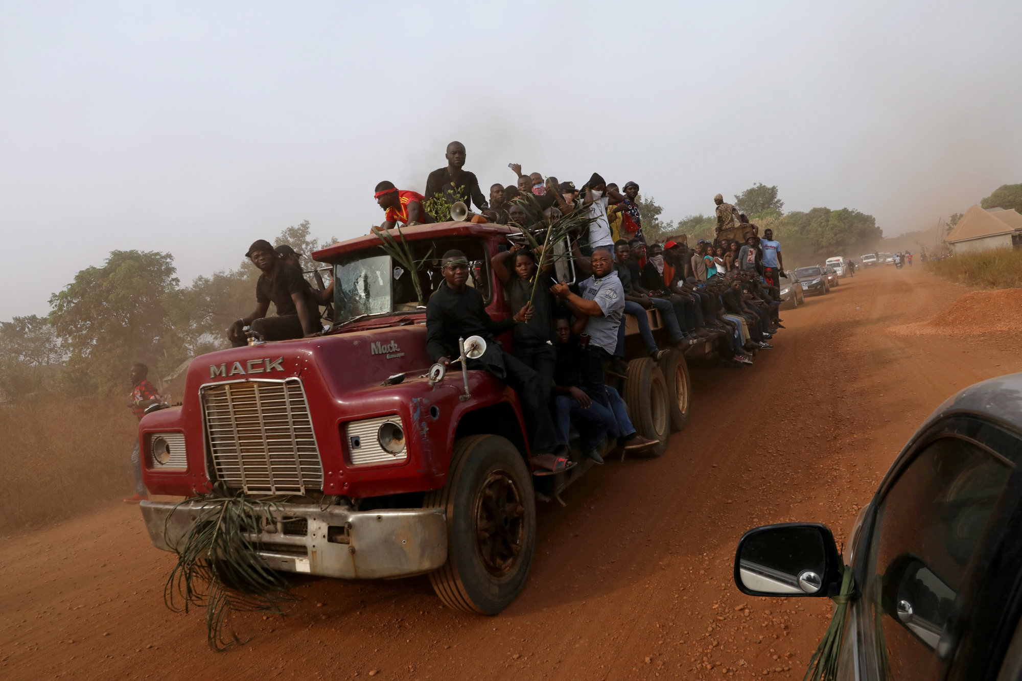 People are seen on a truck carrying the coffins of people killed by the Fulani herdsmen, in Makurdi, Nigeria, Thursday. | REUTERS