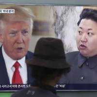 A man watches a TV screen showing U.S. President Donald Trump and North Korean leader Kim Jong Un during a news program at Seoul Railway Station in the South Korean capital in August. | AP