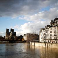 The rear of the Notre Dame Cathedral in Paris is seen Friday as the muddy Seine River covers its banks after days of almost nonstop rain caused flooding in France. | REUTERS