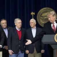President Donald Trump welcomes Senate Majority Leader Mitch McConnell (third from left) to the podium to speak during a news conference after participating in a Congressional Republican Leadership Retreat at Camp David, Maryland, Saturday. Also pictured (from left) is House Speaker Paul Ryan, CIA Director Mike Pompeo and Vice President Mike Pence (second from right). | AP