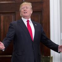 U.S. President Donald Trump responds to a reporter\'s question after participating in the swearing-in ceremony for Alex Azar, secretary of Health and Human Services, in the Roosevelt Room of the White House on Monday. | POOL / VIA BLOOMBERG