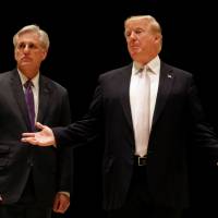 U.S. President Donald Trump speaks Sunday as he and House Majority Leader Kevin McCarthy arrive for dinner at Trump\'s golf club in West Palm Beach, Florida. | REUTERS