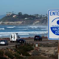 A tsunami sign is shown along the coastal highway in Cardiff, California, Tuesday. | REUTERS