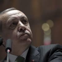 Turkey\'s President Recep Tayyip Erdogan listens to cheering supporters as he addresses his lawmakers at the parliament in Ankara, Turkey, on Tuesday. | AP