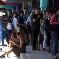 People line up in Buenos Aires on Wednesday during a vaccination campaign for yellow fever, dengue, chikungunya and Zika after the World Health Organization issued recommendations for travelers heading to certain parts of Brazil and Southeast Asia. | REUTERS