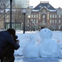 A snowman is seen near Tokyo Station on Tuesday, a day after the capital saw its heaviest snowfall in four years. | YOSHIAKI MIURA