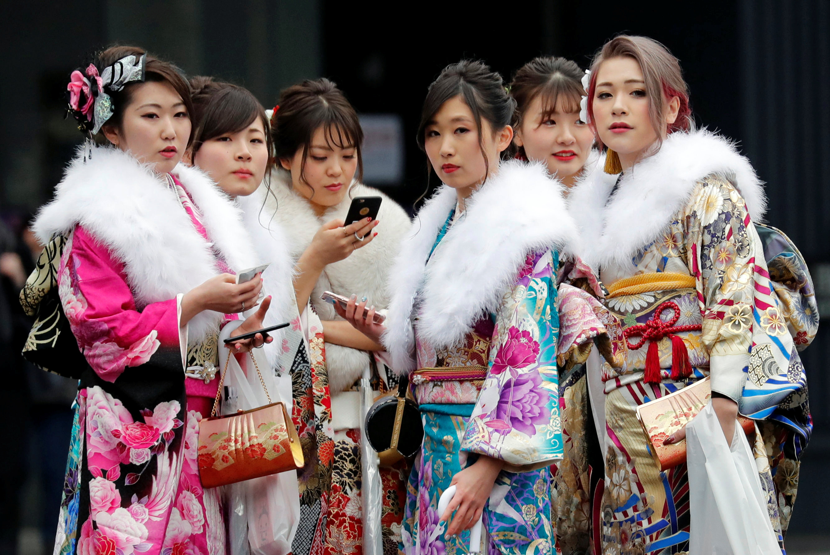 Women wearing kimono attend their Coming-of-Age Day celebration ceremony at an amusement park in Tokyo on Jan. 8. According to data provided by the 23 ward offices, 10,959 new non-Japanese adults live in central Tokyo, or 13 percent of the 83,764 new adults living in the city. | REUTERS