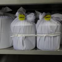 An urn containing the ashes of a Yokosuka, Kanagawa Prefecture, resident is covered with a clean cloth and tied together with the urn of her husband, in line with her wishes. The woman died a few months after she signed up for the city\'s \"ending plan support\" program, where participants pay while they are alive for their remains to be placed in a local temple after they die. | MIZUHO AOKI