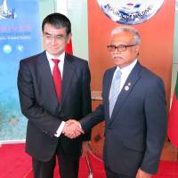 Foreign Minister Taro Kono and his Maldivian counterpart Mohamed Asim shake hands in Male, the capital of the Maldives, on Saturday. | KYODO