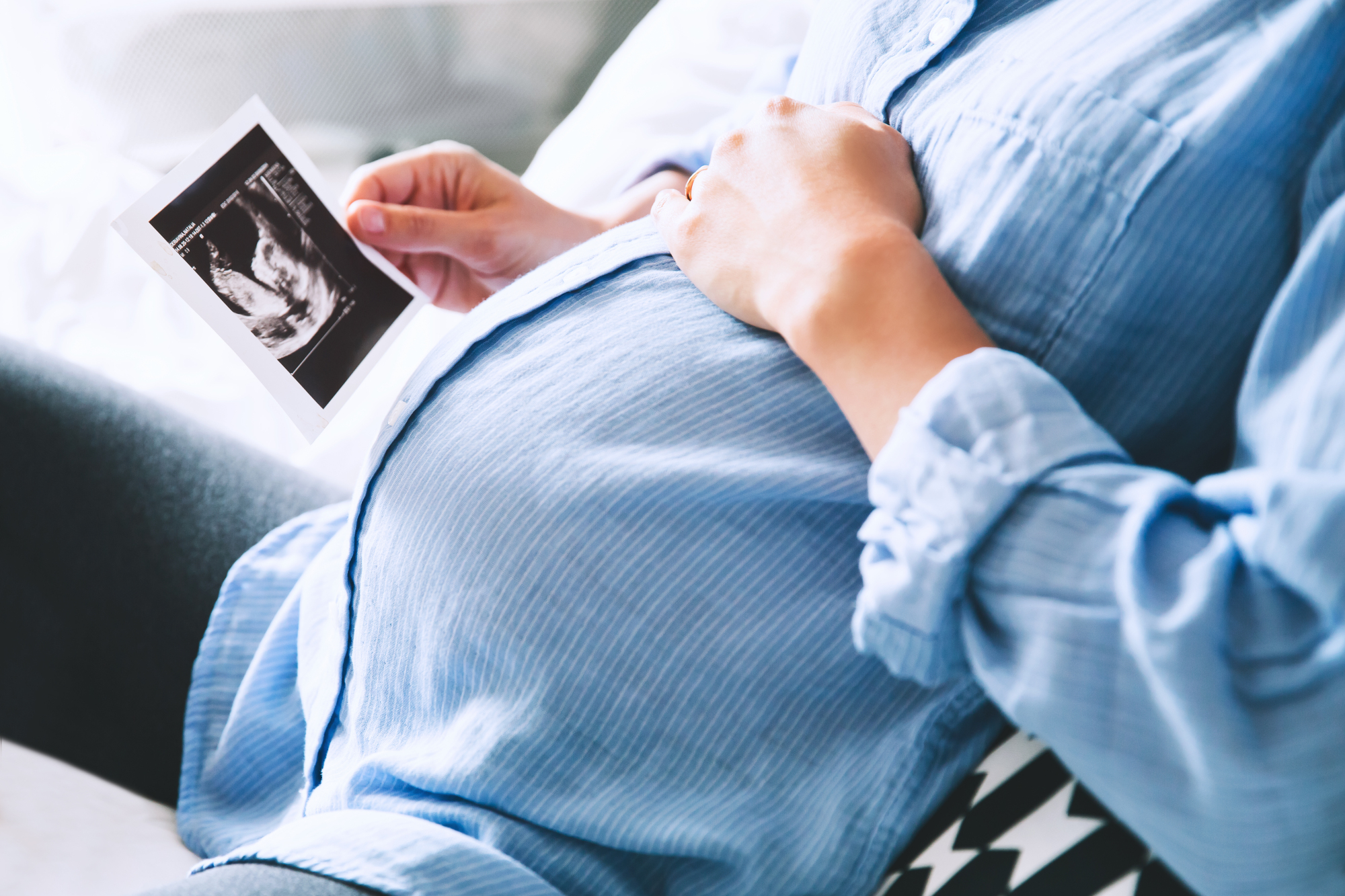 A pregnant woman holds an ultrasound photo in this undated photo. Japan is set to allow more institutions to conduct blood-based prenatal testing for chromosomal abnormalities linked to disorders such as Down syndrome. | GETTY IMAGES