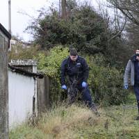 Irish police search a property in Dundalk, Ireland, Thursday close to the scene of a murdered Japanese man. An 18-year-old Egyptian man has been arrested on suspicion of Wednesday\'s knife murder and subsequent assaults on two local men. | NIALL CARSON / PA WIRE / PA / VIA AP