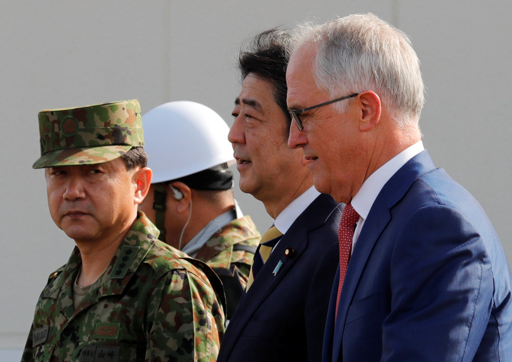 Prime Minister Shinzo Abe and Australian Prime Minister Malcolm Turnbull arrive at Narashino exercise field in Chiba Prefecture on Thursday.  | REUTERS