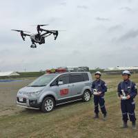 Officials from the Yaizu Crisis Management Division use a drone to locate a swimmer in need of help in the ocean as part of an emergency drill. | COURTESY OF YAIZU CITY CRISIS MANAGEMENT DIVISION
