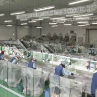 Employees divide used food trays into categories for recycling. | FP CORP.