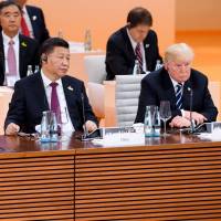 Chinese and U.S. Presidents Xi Jinping and Donald Trump, shown at the Group of 20 summit in July in Germany, both have designs on Europe and not all of their plans are friendly. | AP