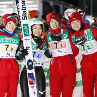 (From left) Japan women ski jumpers Yuki Ito, Sara Takanashi, Kaori Iwabuchi and Yuka Seto celebrate their team victory in a World Cup event on Saturday in Zao, Yamagata Prefecture. | KYODO