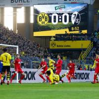 Shinji Kagawa (23) scores for Borussia Dortmund against Freiburg in the Bundesliga on Saturday. | REUTERS