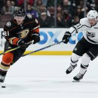 The Ducks\' Chris Wagner controls the puck as the Kings\' Kyle Clifford defends in the first period on Friday in Anaheim, California. | KELVIN KUO / USA TODAY / VIA REUTERS