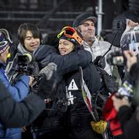 Ayumu Hirano (center) is congratulated after winning the superpipe final at the Winter X Games on Sunday in Aspen, Colorado. | AP