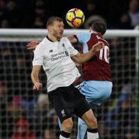 Liverpool\'s Ragnar Klavan (left) vies for the ball with Burnley\'s Ashley Barnes in Premier League action on Monday. | REUTERS