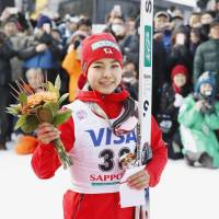 Sara Takanashi poses for pictures after finishing third at a World Cup ski jumping meet in Sapporo on Saturday. | KYODO