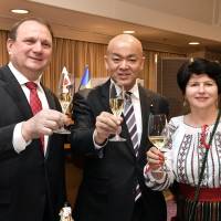 Moldovan Ambassador Vasile Bumacov (left) and his wife, Ludmila, raise their glasses during a toast with Manabu Horii, parliamentary vice-minister for foreign affairs, during a campaign to promote Moldovan wine and products such as nuts, dried fruit and honey by the Moldova Investment and Exports Promotion Organization in Japan at Hotel Okura Tokyo on Dec. 18. | YOSHIAKI MIURA