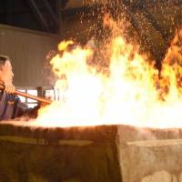 A worker fires up a furnace Wednesday at Nittoho Tatara steel works in the town of Okuizumo, Shimane Prefecture. The company is the country\'s only works that still makes steel for swords using the traditional tatarabuki method. | KYODO