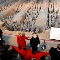 French President Emmanuel Macron and his wife, Brigitte, visit a museum in Xi\'an, China, on Monday. On the first day of his three-day trip to China Macron went out of his way to win the heart of Chinese President Xi Jinping, offering him a horse of the elite French Republican Guard. Macron selected an 8-year-old brown gelding named Vesuvius, and braved stringent Chinese quarantine checks to offer it to Xi. | REUTERS