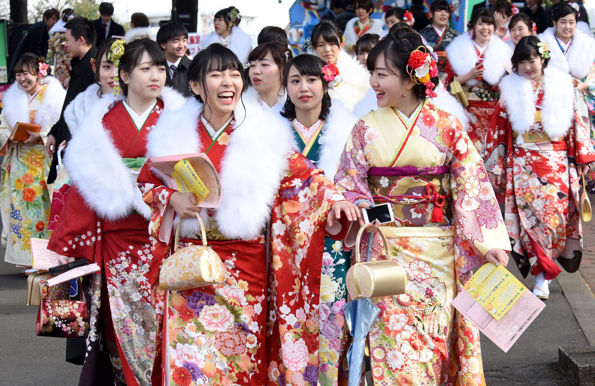 Kimono-clad women enter a ceremony at the Toshimaen amusement park in Tokyo's Nerima Ward to celebrate Coming of Age Day on Monday. Such ceremonies were held across the country to recognize more than a million new 20-year-olds. | SATOKO KAWASAKI