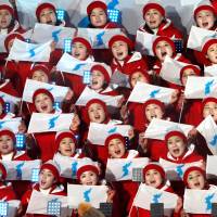 Cheerleaders of North Korea hold unification flags during the opening ceremony at the Pyeongchang Olympic Stadium on Feb. 9. | REUTERS